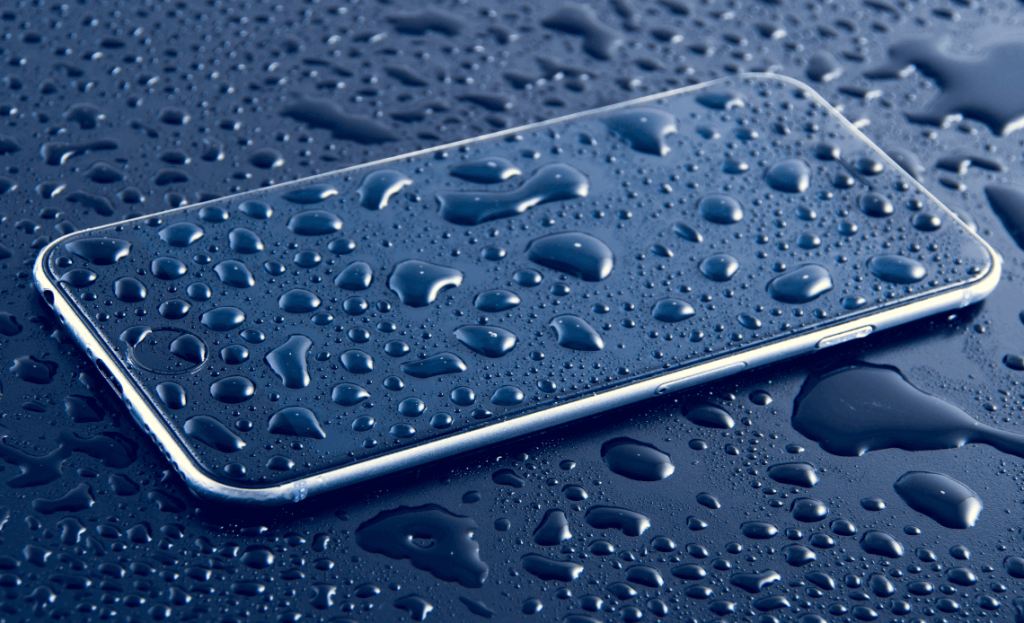 Wet smartphone covered in water drops, emphasizing water-resistant feature